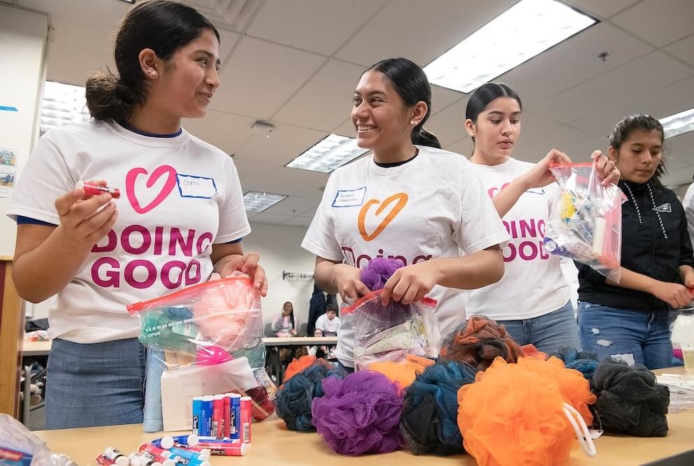 Students help pack essential supplies for families